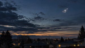 Silver unidentified object in the evening sky over Lakewood, Colorado`